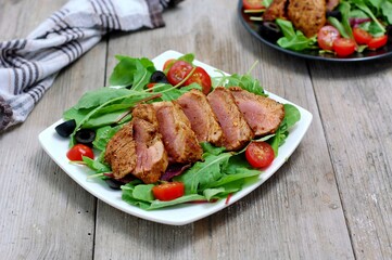 Fresh vegetable salad from tomato,lettuce, black olive with pork fillet