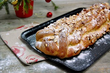 Christmas cake with almond and sugar on glack plate