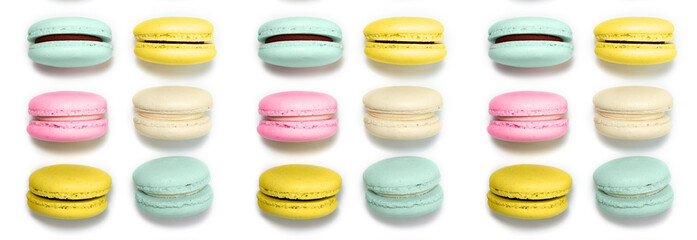 Almond cookies, in pastel colors on a white background. Traditional French multicolored dessert, close-up. banner