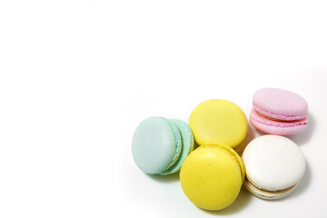 Almond cookies, in pastel colors on a white background. Traditional French multicolored dessert, close-up.