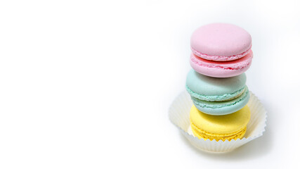Almond cookies, in pastel colors on a white background. Traditional French multicolored dessert, close-up.