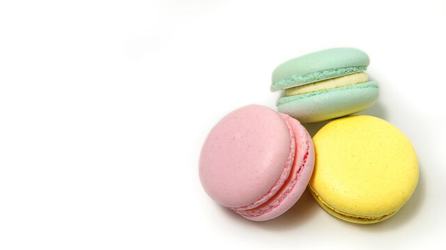Almond cookies, in pastel colors on a white background. Traditional French multicolored dessert, close-up.