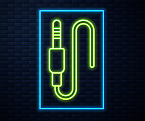 Glowing neon line Audio jack icon isolated on brick wall background. Audio cable for connection sound equipment. Plug wire. Musical instrument. Vector.