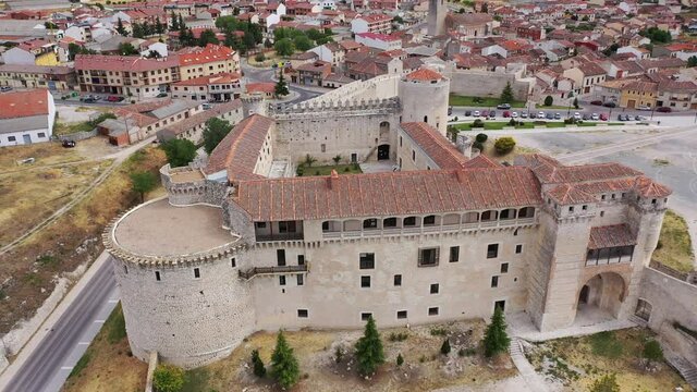 Aerial view of ancient Castle of Dukes of Alburquerque on background with Cuellar cityscape in summer day, Spain
