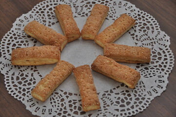 Homemade Crunchy Biscuits Arranged in a Circle on Lace Doily