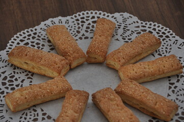 Homemade Crunchy Biscuits Arranged in a Circle on Lace Doily
