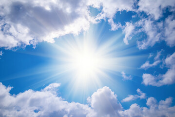 Naklejka na ściany i meble sparkle sun on the blue sky among dense clouds, concept natural background