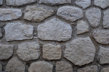 Stone wall texture. Decorative wall background with mosaic stones. Antique stone wall