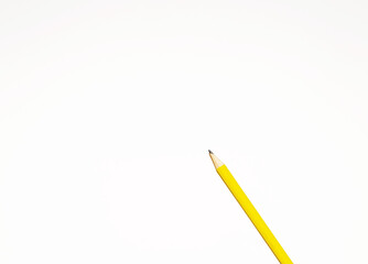 Presentation template with copy space by top view close up macro photo of wooden yellow pencil isolated on white paper that look minimalist and clean. Pencil on paper. Space for text.