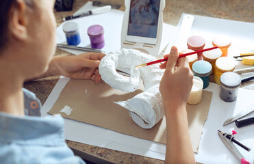 Teenager girl studying online using smartphone, video conferencing, videocall, distance education, learning at home.