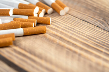 cigarettes on wooden background, close-up of a cigarette with place for text