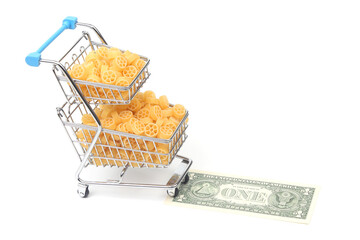 italian pasta in a grocery basket from the market with a dollar bill on a white background. flour products and food in cooking
