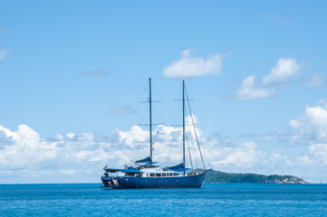 Fototapeta premium Sailing yacht cruise in the blue sea and sky