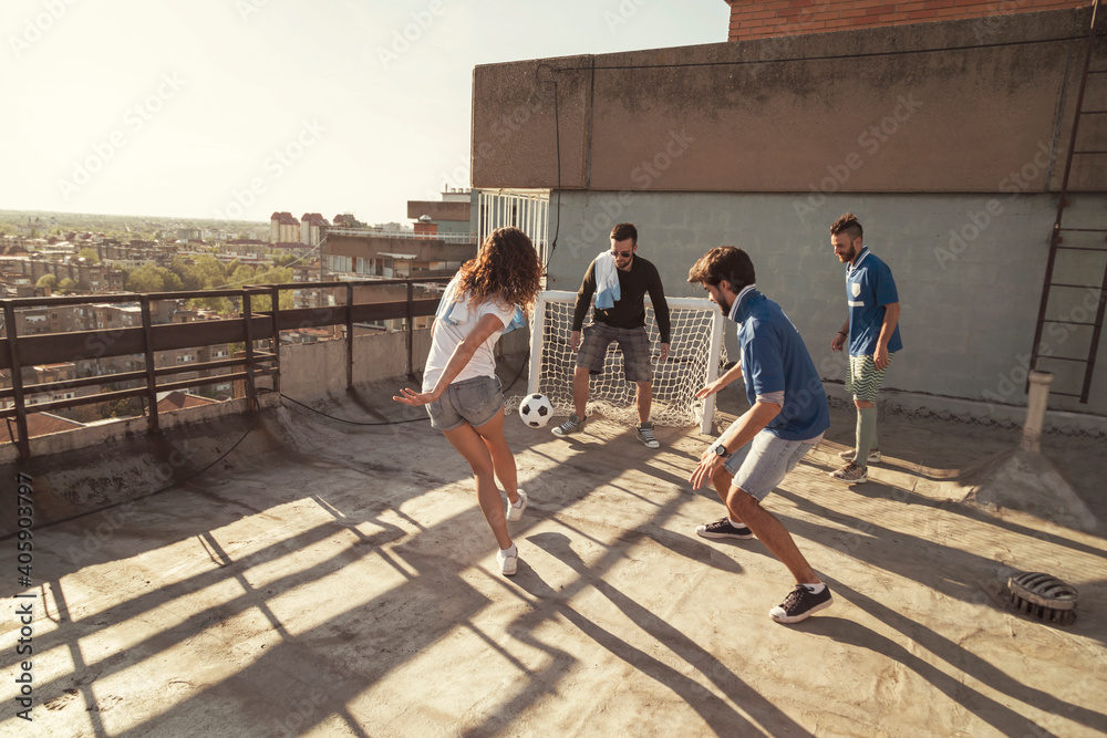 Canvas Prints People having fun playing football on building rooftop terrace