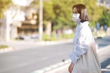 Fototapeta premium Asian women with face mask in bus stop
