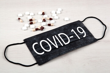 medical mask with the inscription covid-19 and medications