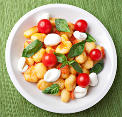 Homemade gnocchi with tomato sauce basil and mozzarella.