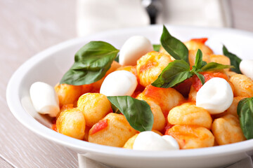 Homemade gnocchi with tomato sauce basil and mozzarella.