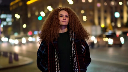 beautiful young woman looking at camera and smiling joyfully. Happy face on street at sunlight. Positive portrait outside.