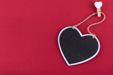 Black chalkboard with heart shape on red background. Free copy space. Concept valentine's day. Concept mother's day.