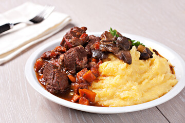 Delicious beef stew with mushrooms and polenta. High quality photo