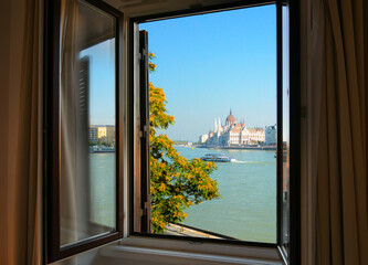 View through an open window of the Budapest Parliament building along the Danube River, in Budapest Hungary.