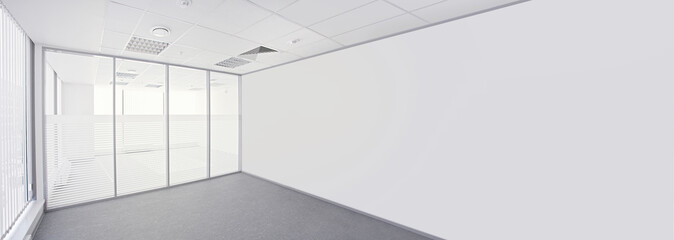 Empty office room with glass walls and glass window