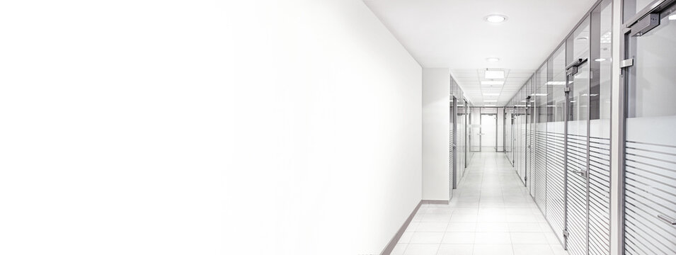 Empty office corridor with glass walls