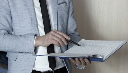 A man signing the contract double checking details . The concept of entering into legal power to take liabilities. Casual wearing.