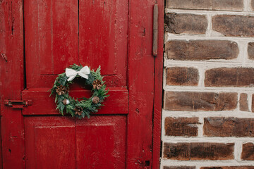 Christmas wreath on wooden red door. Christmas decor self made.