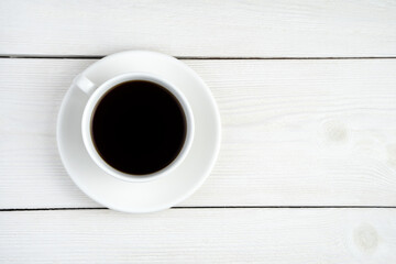 Ceramic white coffee cup on white. Top view with space to copy. The concept of coffee backgrounds.