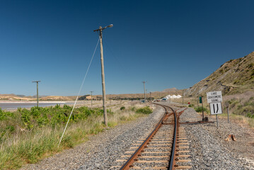 Fototapeta na wymiar View along railway tracks to a siding leading to a saltworks facility.