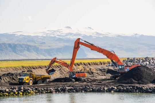 diggers digging sand in Landeyjahofn port in south Iceland