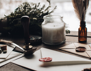 Letter seal with wax seal stamp on the wood table. Vintage notary stamp and sealed envelope. Post concept. Sealing wax. Wax seal. Dark academia style. Scandinavian hygge styled composition.