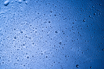 water drops on glass on blue background