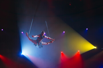 Fototapeta na wymiar Circus actress acrobat performance. The acrobat perform acrobatic elements in the air