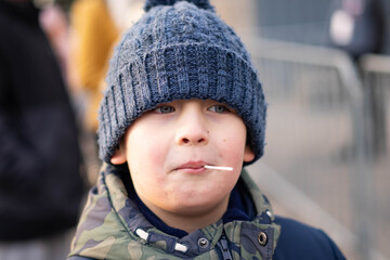 White boy during cold day eat lolipop