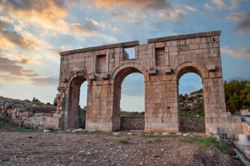 Patara ancient city columns with cloudy sky. Old city gate. Year of Patara