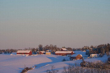 winter landscape with snow covered fields and farms