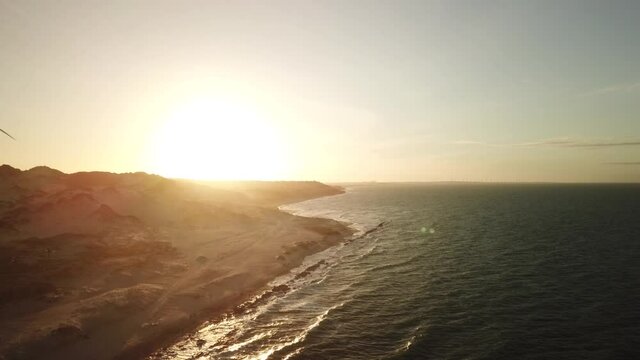 Aerial view in over exposed light by sunset of sand cliff in Canoa Quebrada Beach, Cear&aacute;, Brazil.