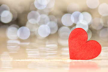 Valentines day background. Red heart on abstract golden background.