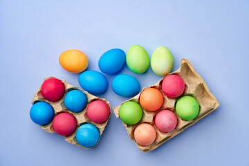 Colorful Easter eggs on blue background top view