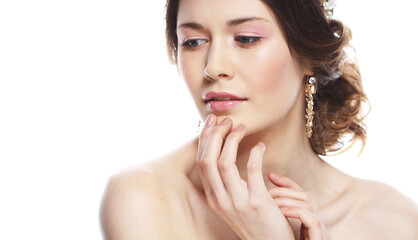 Fototapeta premium Fashionable young bride. Studio portrait over white background. Beautiful model with bridal makeup and hairstyle.