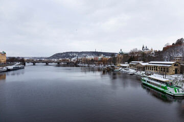 Snowy Prague Lesser Town with Prague Castle above River Vltava, Czech republic