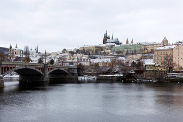 Snowy Prague Lesser Town with Prague Castle above River Vltava, Czech republic