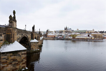 Snowy Prague Lesser Town with Prague Castle and Charles Bridge above River Vltava, Czech republic