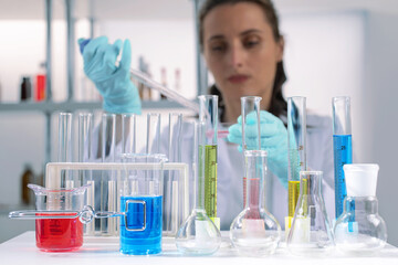 laboratory equipment, supplies, jars, bottles, cylinders, beakers. Lab assistant holding petri...