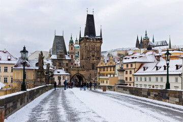 Snowy Prague Lesser Town with Prague Castle and Charles Bridge above River Vltava, Czech republic