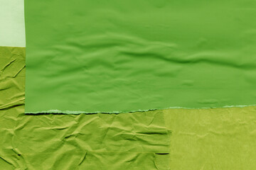 Green torn paper collage close-up. Texture made from various paper and cardboard parts. Damaged old paper background. Vintage blank wallpaper. Material design backdrop.