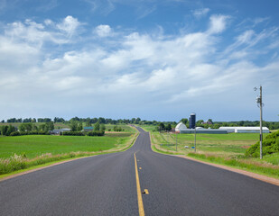 Rural blacktop road with farms on a sunny spring afternoon in Minnesota © Daniel Thornberg